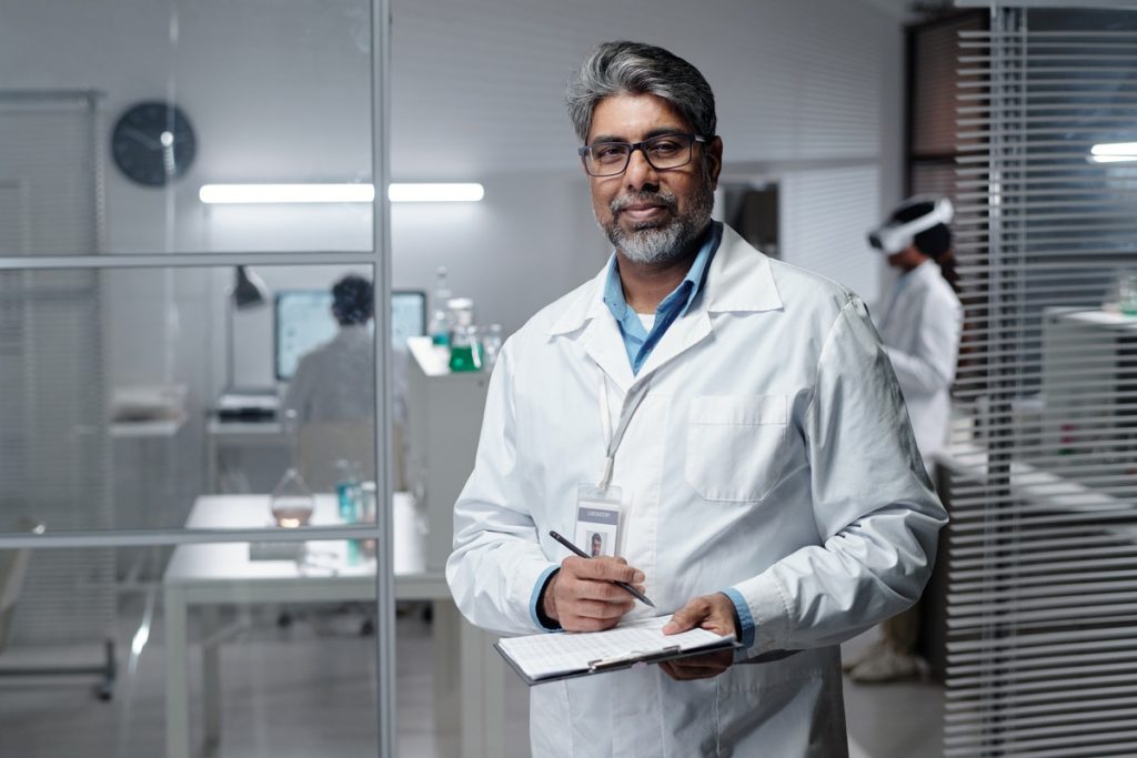 doctor taking notes in modern medical laboratory setting
